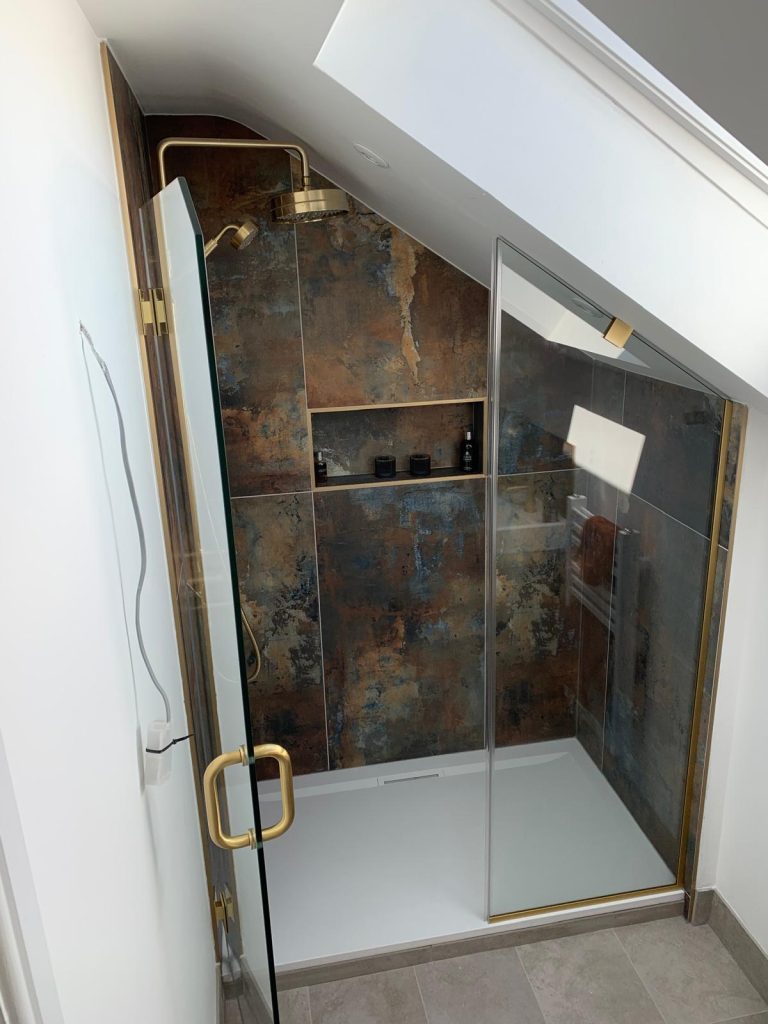 Custom frameless shower glass enclosure in contemporary tiled bathroom