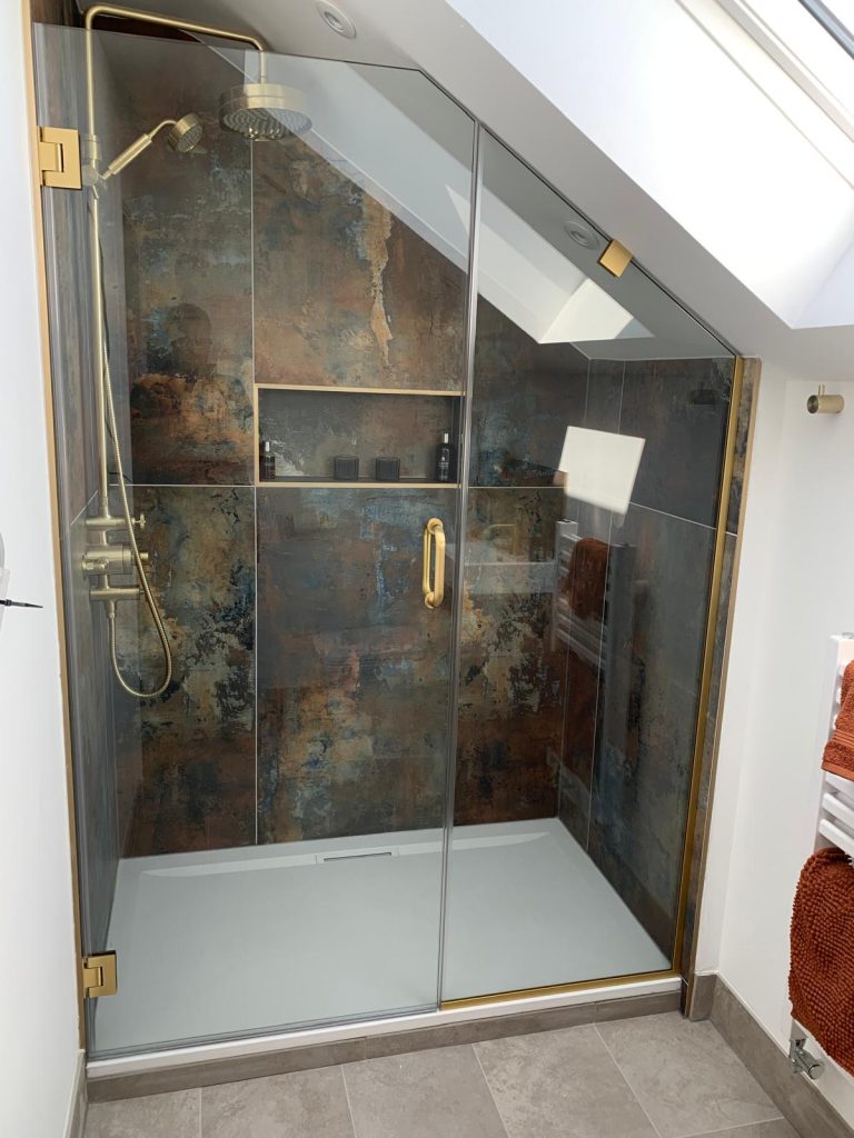 Precision-cut bespoke shower glass fitted under angled ceiling