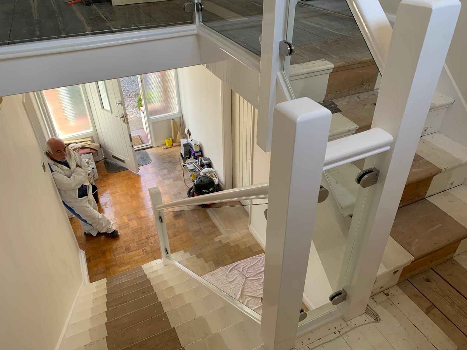 Modern glass balustrade on white-painted wooden staircase installed by CS Glaziers Chester”